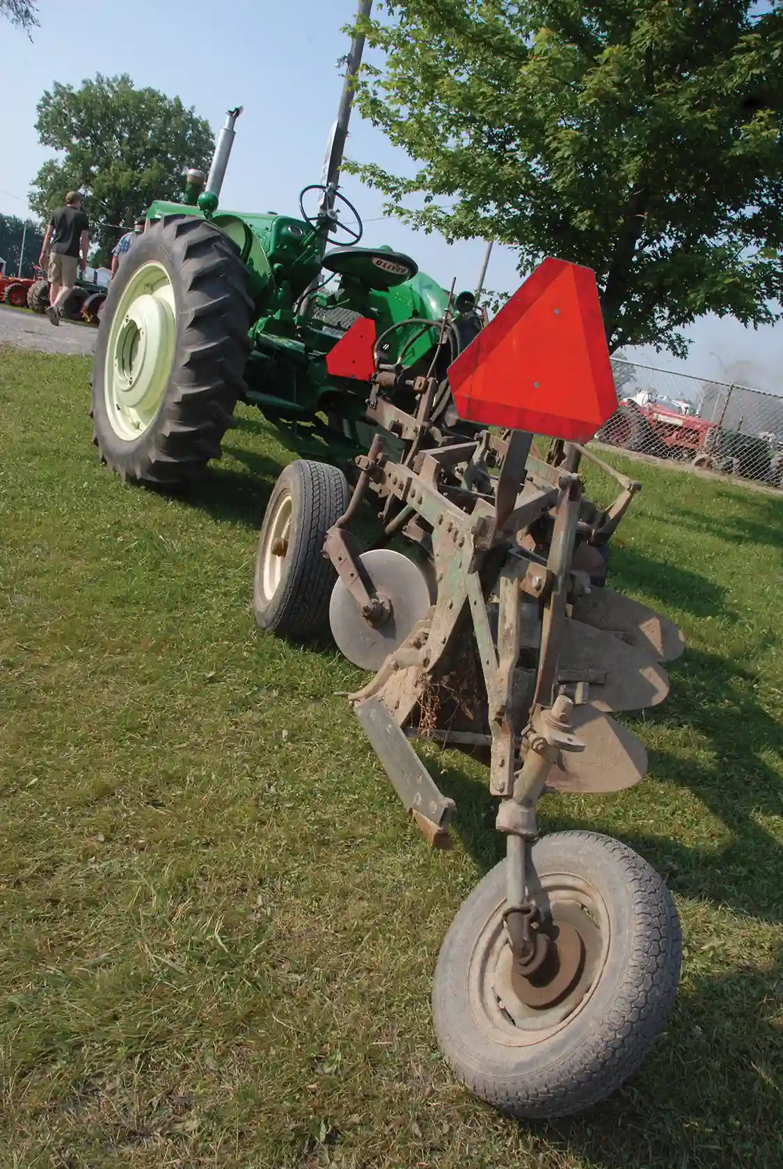Looks like this is still a working tractor. Nafziger’s Oliver is hitched to an Oliver three-bottom plow that looks well (and recently) used. Oliver was well known for their high-quality plows, and the Oliver tractor originated in 1929 when the Oliver Chilled Plow Works absorbed the ailing but well-known Hart-Parr company. Oliver wanted to build tractors and an established line made it a turnkey operation. It took nearly a decade for the Hart-Parr name to fade away completely.