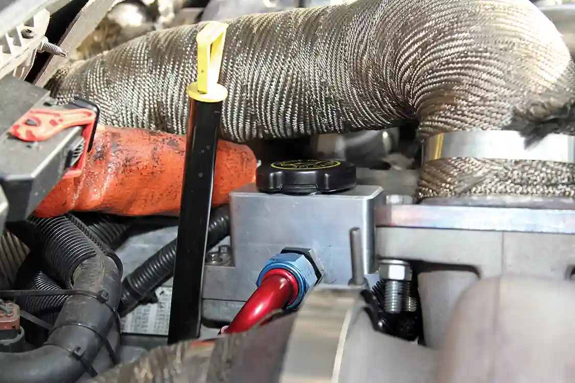 Hot pipes are heat-wrapped to reduce under-hood temperatures. In order to fit the S480 turbo, the oil dipstick had to be relocated.
