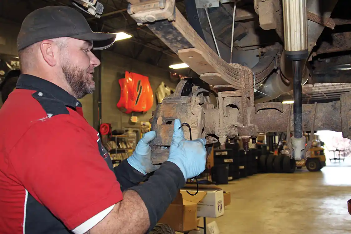 4. While the old gear oil is draining Nelson begins to tear down the axle removing the calipers, rotors, hubs, backing plates and parking brake cables.