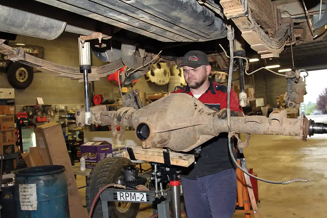 10. Then he can remove the U-bolts and lower the axle assembly down from the truck with the transmission jack. If you don’t have a transmission jack a couple of strong friends will work, but you may need to supply pizza and beer.