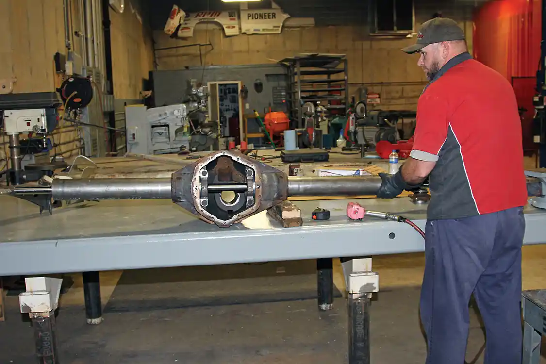 19. After the other axle tube was installed the housing was moved to a workbench where Nelson installed the alignment jig and polished stainless steel shaft to keep everything aligned and true while welding.