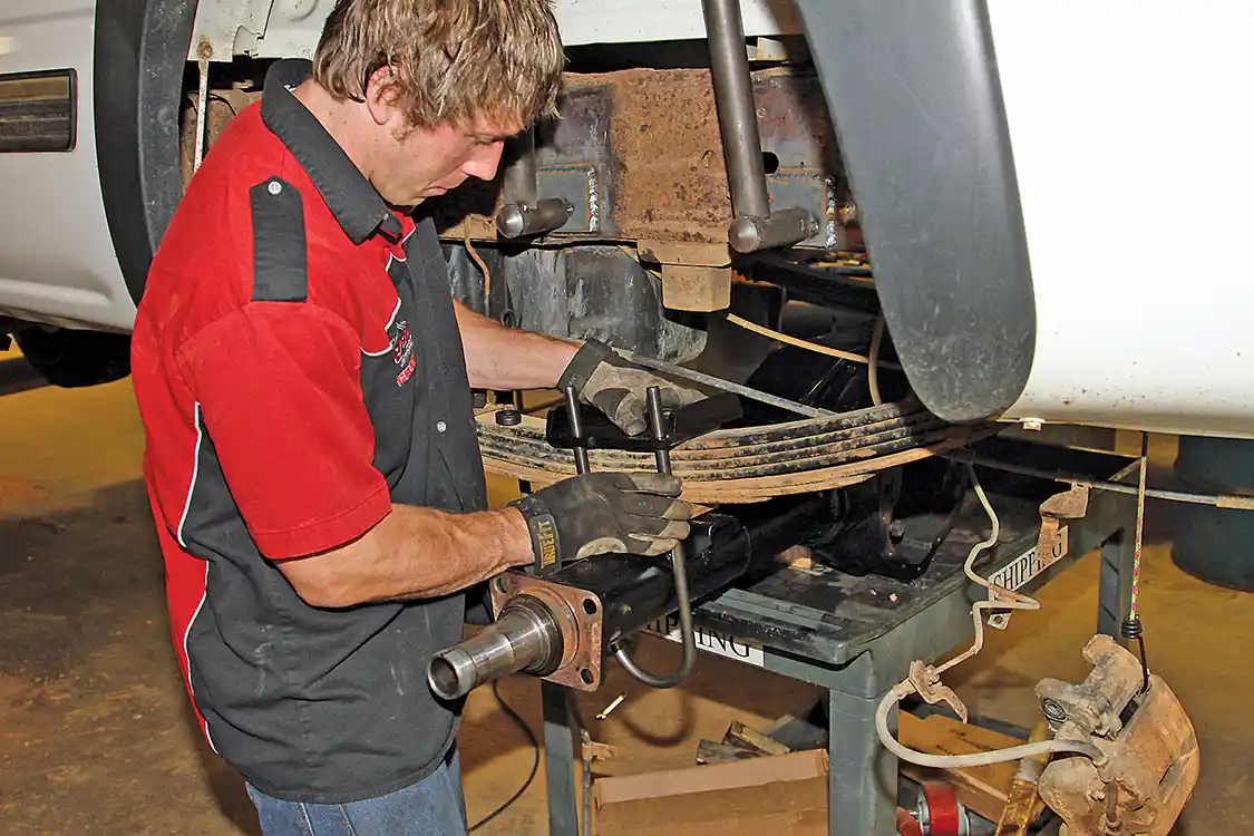 23. After a fresh coat of paint Powell aligns the housing under the truck and mounts it to the new spring perches he installed and mounts it with upward facing U-bolts for better ground clearance.