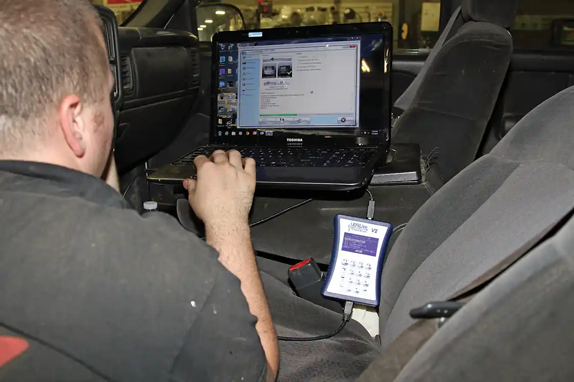 37. To correct the speedometer and maintain the shift points <a href="https://www.fleeceperformance.com/">Fleece Performance Engineering</a> tuned into the truck; Miltier used the EFILive V2 module and a laptop to interface with the truck and modify the gear ratio.