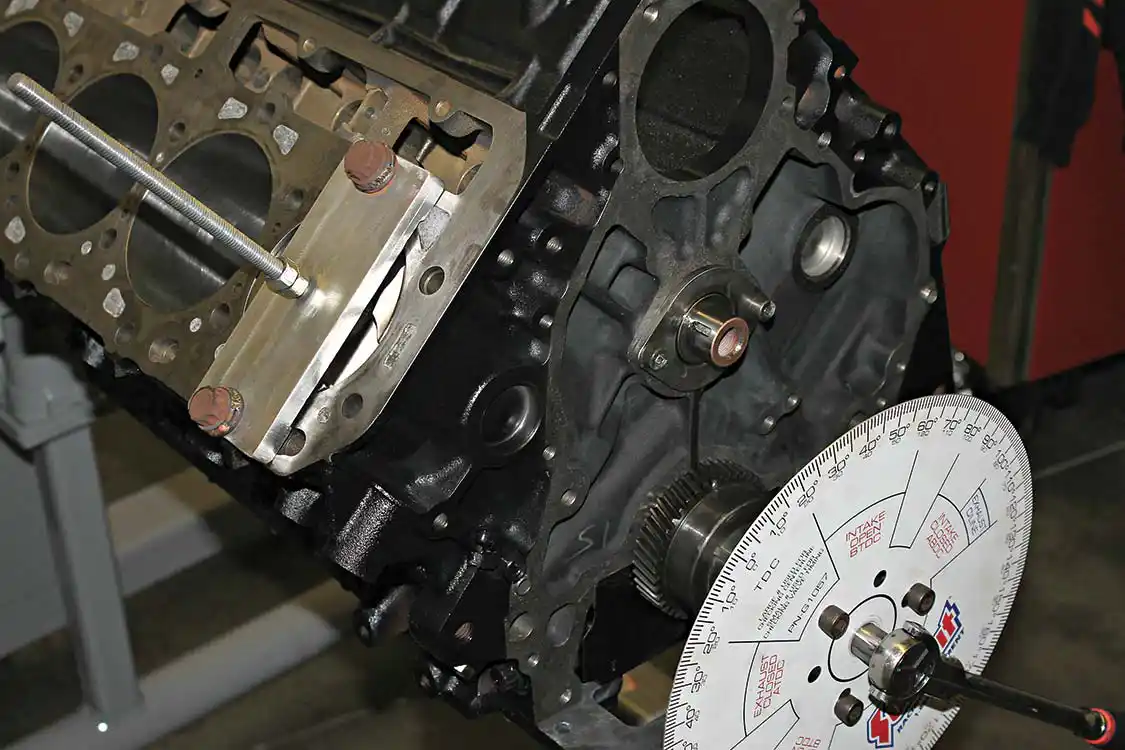 6. Using a strap plate, Empire Diesel technicians check for true top dead center (TDC) of the #1 piston before going further with the cam installation and degreeing process. A reputable engine builder may have another method of checking this, but getting the camshaft set perfectly will ensure that maximum valve lift and duration is held without damaging pistons or cylinder heads due to incorrect clearance.