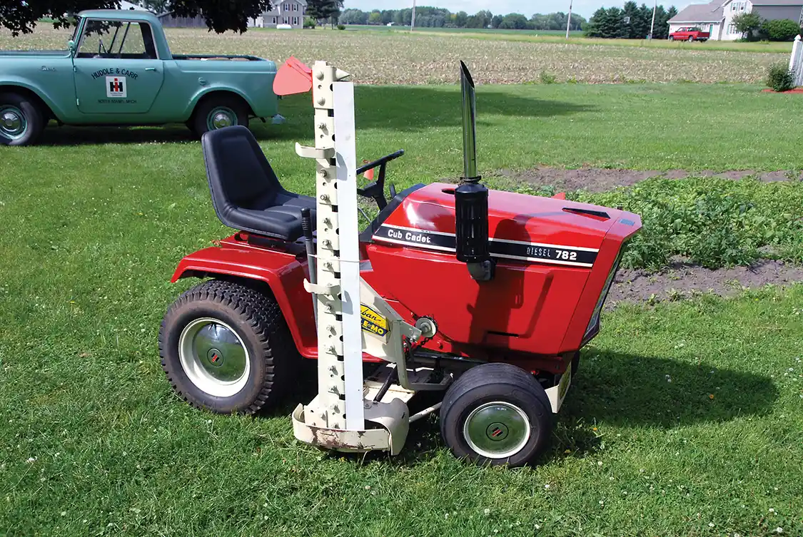 Herb Huddle’s 1984 782D Cub Cadet is a rare bird. It mounts a Model 402D Haban Sickle-Mo sickle mower, and yes, those snazzy hubcaps were part of the package. Some purists may note the incorrect hood from a gas machine, a fill-in until a proper diesel hood can be obtained. Also, the muffler is supposed to be pointing forward, not up, and with a short chrome extension. (This is the way Herb wanted it because it looks “tractory.”) Herb, former co-owner of an IH dealership, has a fantastic and esoteric IH collection, including the 1962 Scout in the background.