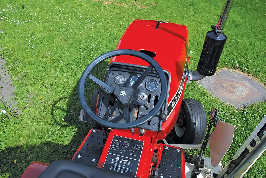 The 782D differs from most lawn tractors its size in having water temp and oil pressure gauges as well as a radiator and a fan. The <a href="https://www.kubotausa.com/">Kubota</a> diesel has a glow system, albeit an old school one, with a fourth glow plug mounted in the dash and observed through a sight hole just to the right of the steering column. The other controls are largely the same as the other 782s, and the fuel tank is located under the seat.