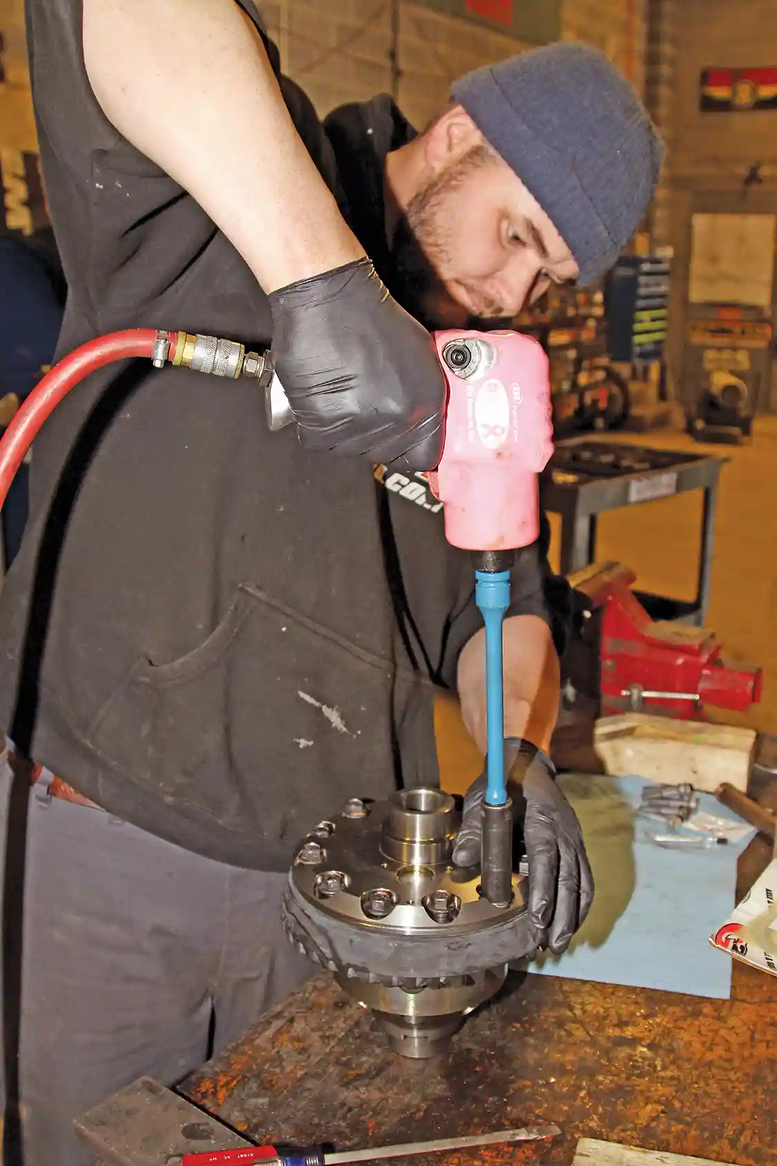 12. Nelson hand-starts all of the bolts, then torques them with a torque bar on his impact gun. Important: Note that the ring gear bolts are left-hand threaded so you turn them left to tighten and right to loosen.