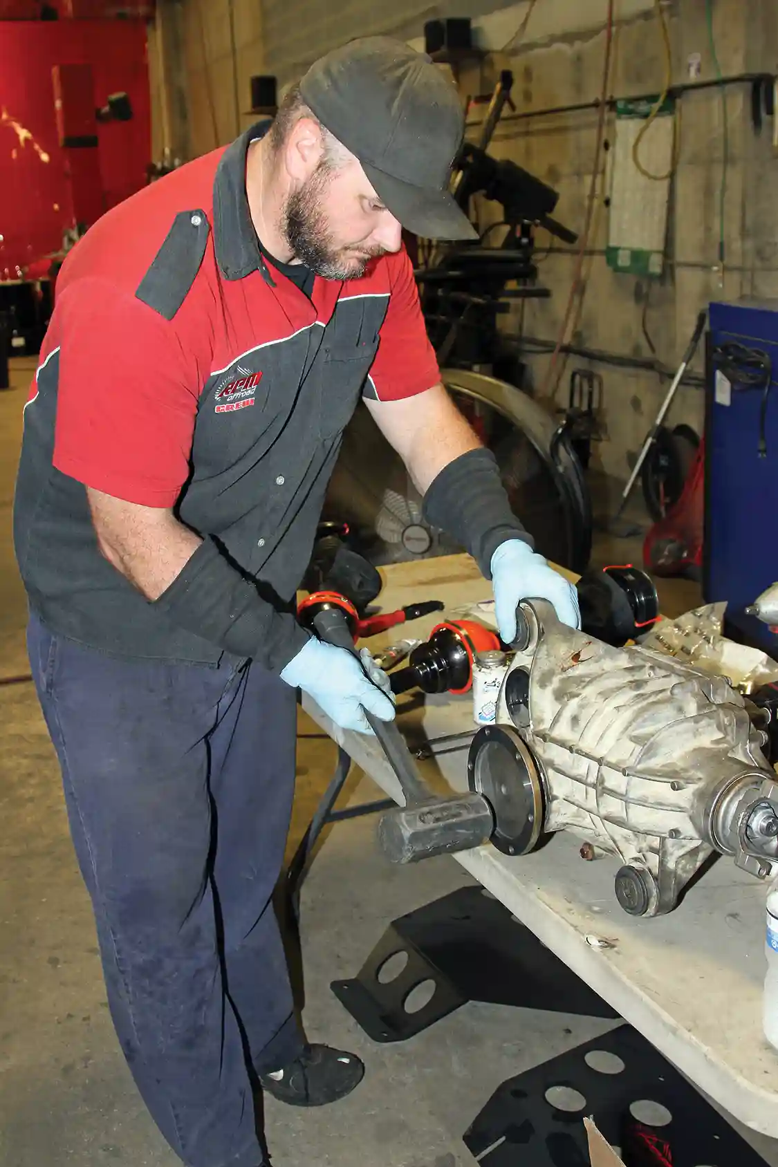 22. After the driver-side shaft is properly located in the housing, Nelson gives it a tap with a dead-blow hammer to seat the retaining ring.
