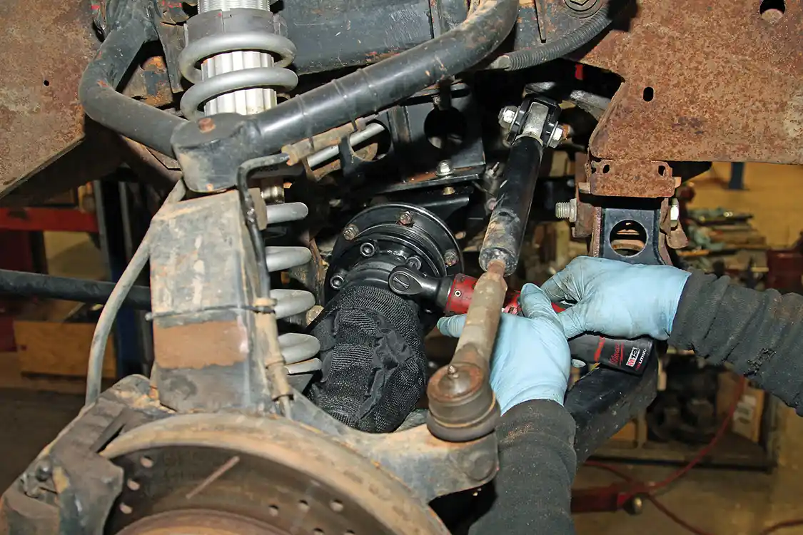 27. After putting Blue T-42 WRP thread locker on the RCV-supplied Allen head mounting bolts, Nelson secures the inner Pro4 CV joints to adaptors already installed on the Fleece axle shafts.