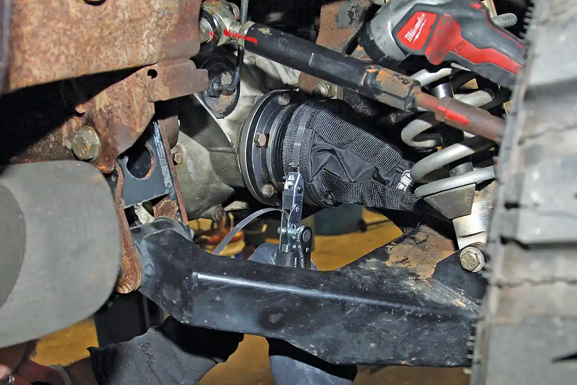 30. To complete the axle installation, Nelson slides the RCV overboots into position and secures them with band clamps using the RCV installation tool. The overboots provide an additional layer of protection for the inner rubber boots.