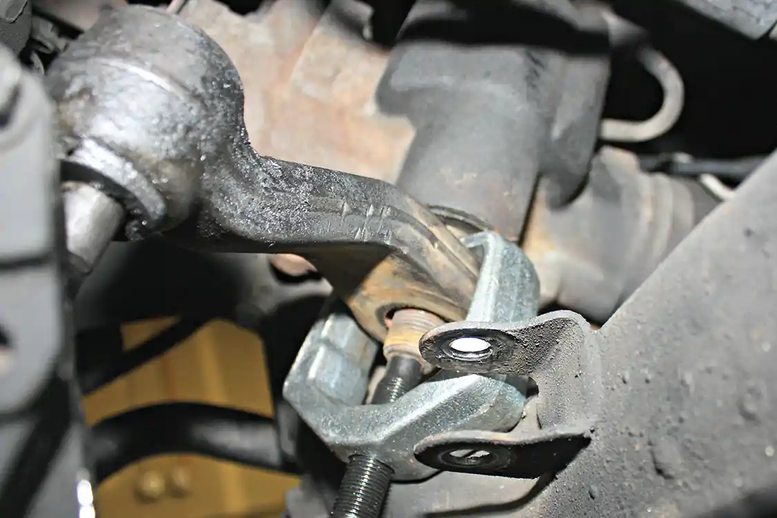 14. Since 90 percent of the factory steering assembly was being replaced on this truck, it made sense to replace the factory Pitman arm as well. Making this swap requires a special tool that can be purchased or rented from just about any parts store. To gain the access and clearance needed for the puller, the steering box must be removed from the frame rail. Power steering lines can remain intact as the box needs to droop just enough to allow the puller to clear the truck's crossmember.