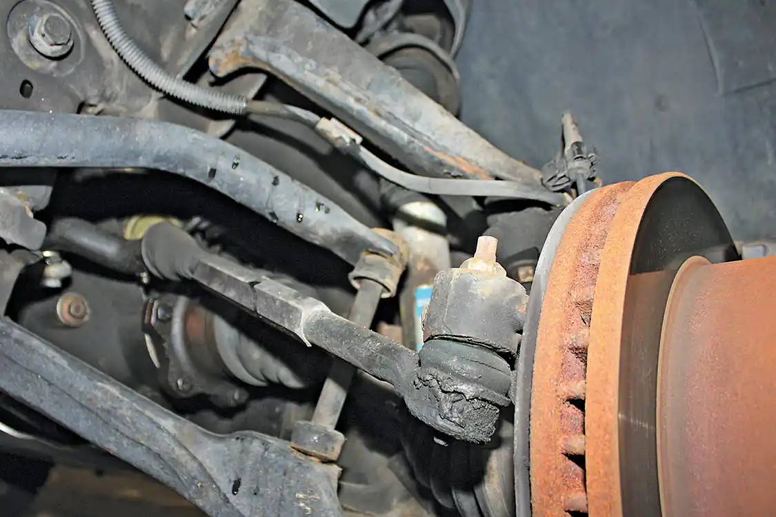 3/ 4. After 142,000 miles, the factory tie rod ends, idler arm and ball joints were starting to show signs of wear and had started to show some play. This caused the truck to wander a bit at highway speeds. While some upgrades had already been done to the front of the truck (notice the tie rod sleeves) the Ultimate Steering Package from Dmax Store includes much stronger tie rods and a straight center link and when paired with their indestructible Death Grip idler arm you’ll see improved steering response and unmatched durability.