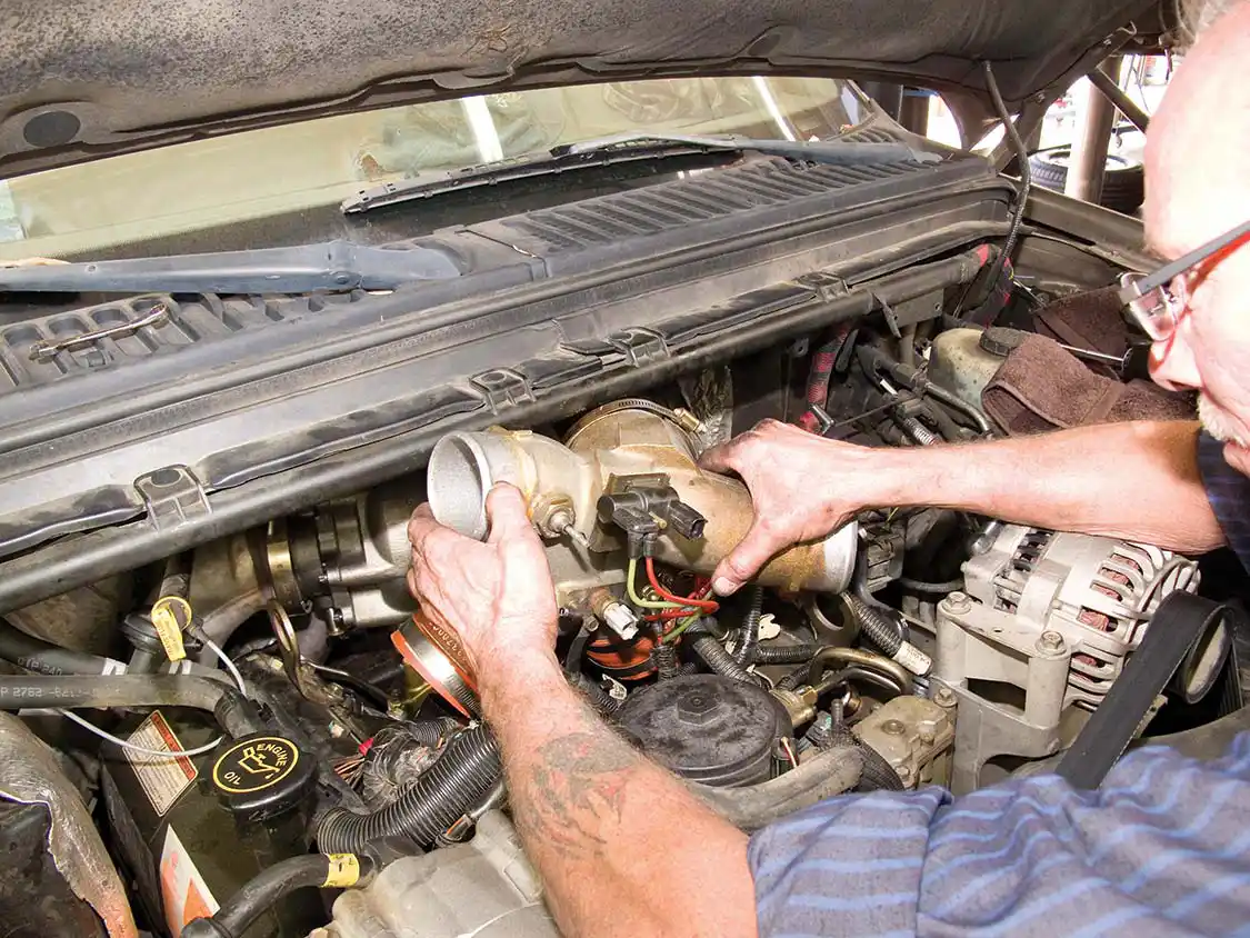 16. The stock air intake manifold is retained for this upgrade. Here you see it being reinstalled.