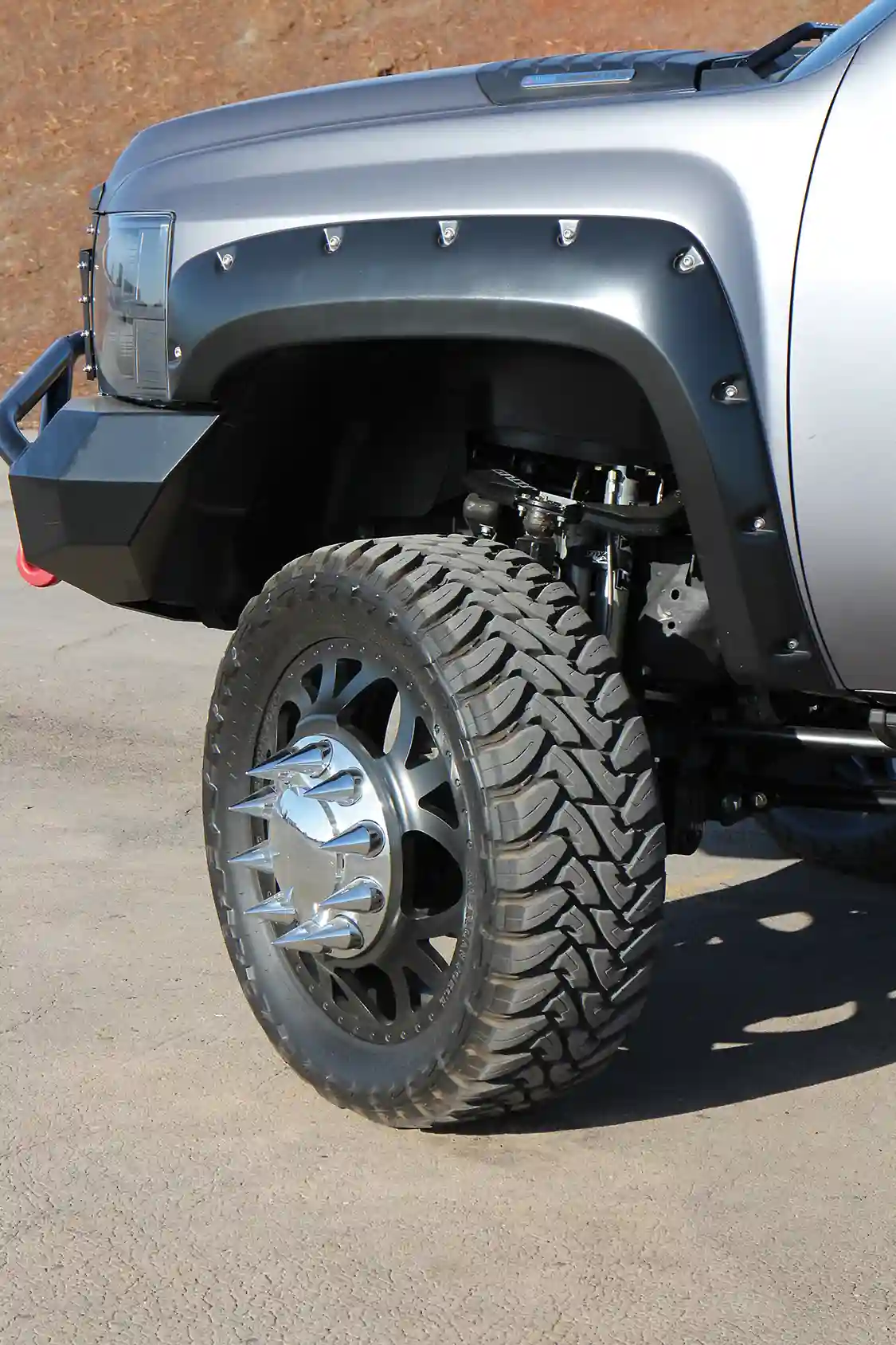 The dually rolls on a set of American Force Weapon forged aluminum 24x8 satin black wheels with Toyo 37x13.5 Open Country M/T rubber. Notice the wicked “spike” lug nuts.