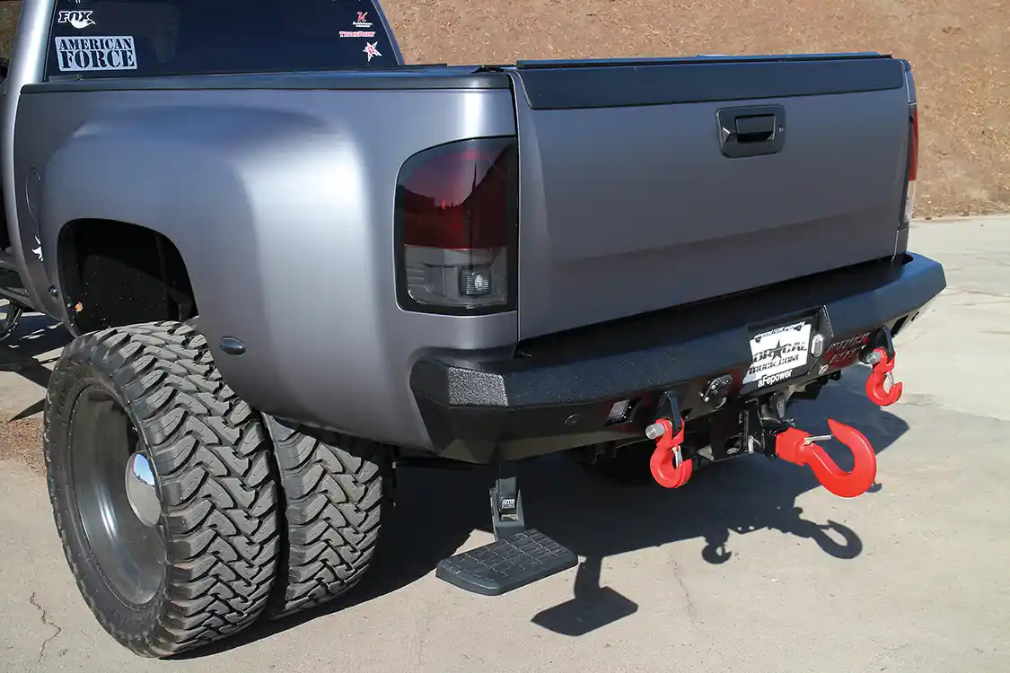 A snug-fitting Winch Ready rear bumper was equipped with a pair of Monster recovery hooks. To gain easier access to the bed, an <a href="https://www.amp-research.com/">AMP Research</a> retractable bed step was installed. A larger Monster recovery hook was stuffed and secured into the trailer hitch receiver.
