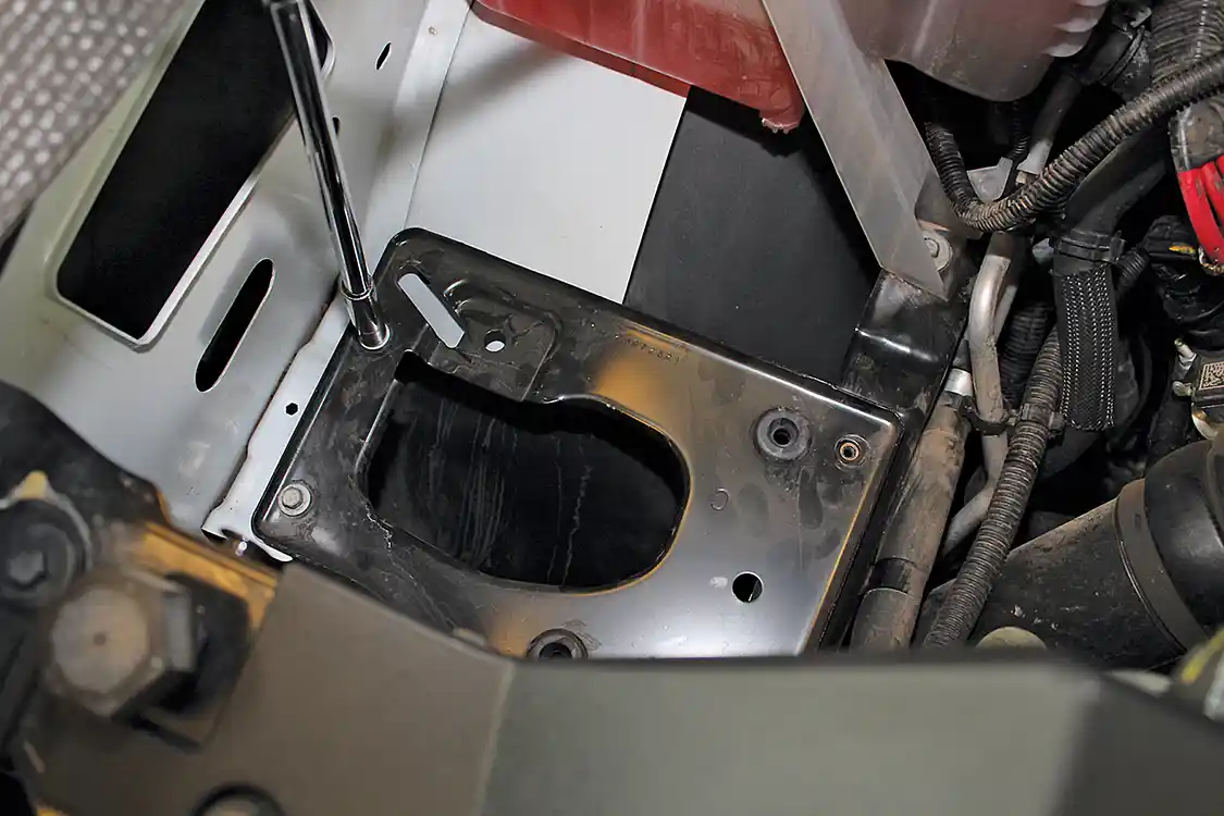 4. Beneath the stock intake box is a flat metal panel that also needs to be removed to make room for the larger AIRAID box. It’s held in place with four 10mm bolts. The plate can be discarded but save the bolts for re-use.
