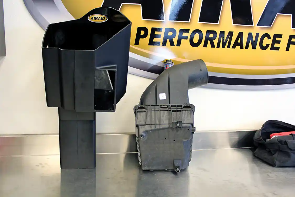 5. The new AIRAID MXP air box dwarfs the factory box. Not only does it accommodate a much larger filter, it greatly increases the amount of cool outside air available to the filter. It’s an open-element design that uses the hood as a lid for the air box; weatherstripping along the top of the box keeps the engine compartment air isolated from the filter.