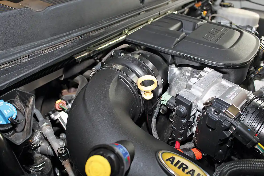 9. AIRAID supplies a hump hose and stainless steel clamps to connect the intake tube to the throttle body. We recommend positioning the hump hose and clamps on the throttle body first and then popping the intake tube into place between the box and the throttle body. It takes a little finesse to get everything positioned just right, but once it’s in, everything fits like a glove.