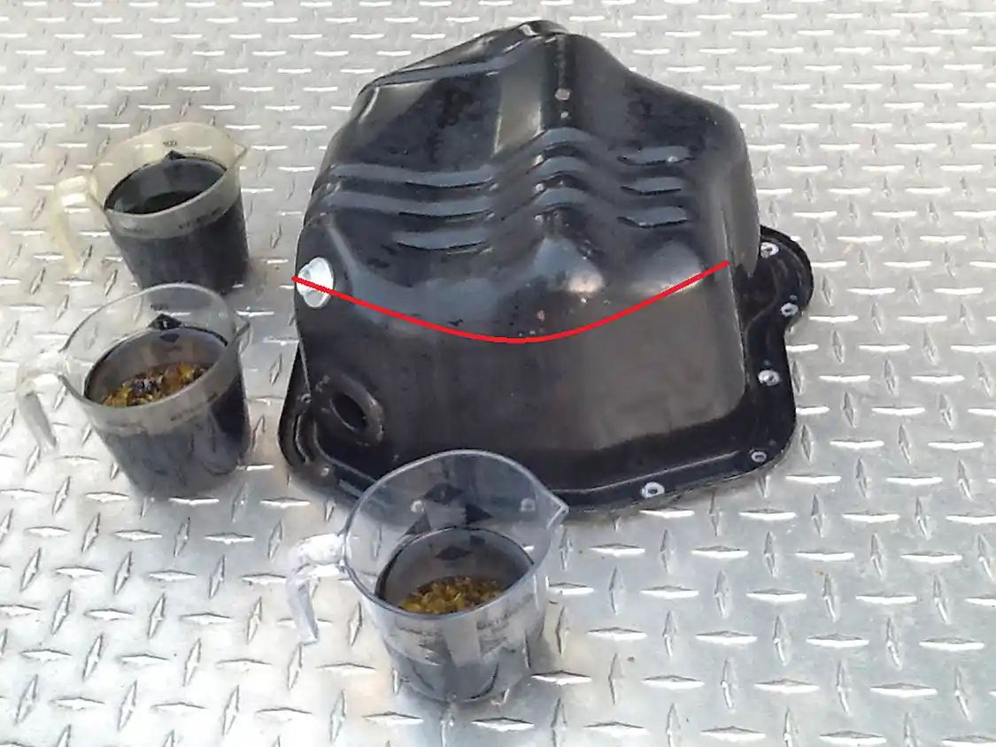 12. Here you see the dreaded hump on the bottom of the OEM Duramax oil pan, or lower oil pan to be exact. This hump retains old oil after every oil change, sort of an oddly designed in-storage system. This old oil quickly contaminates your new oil after each oil change. In our humble opinion only camels should have humps for storage, not oil pans.