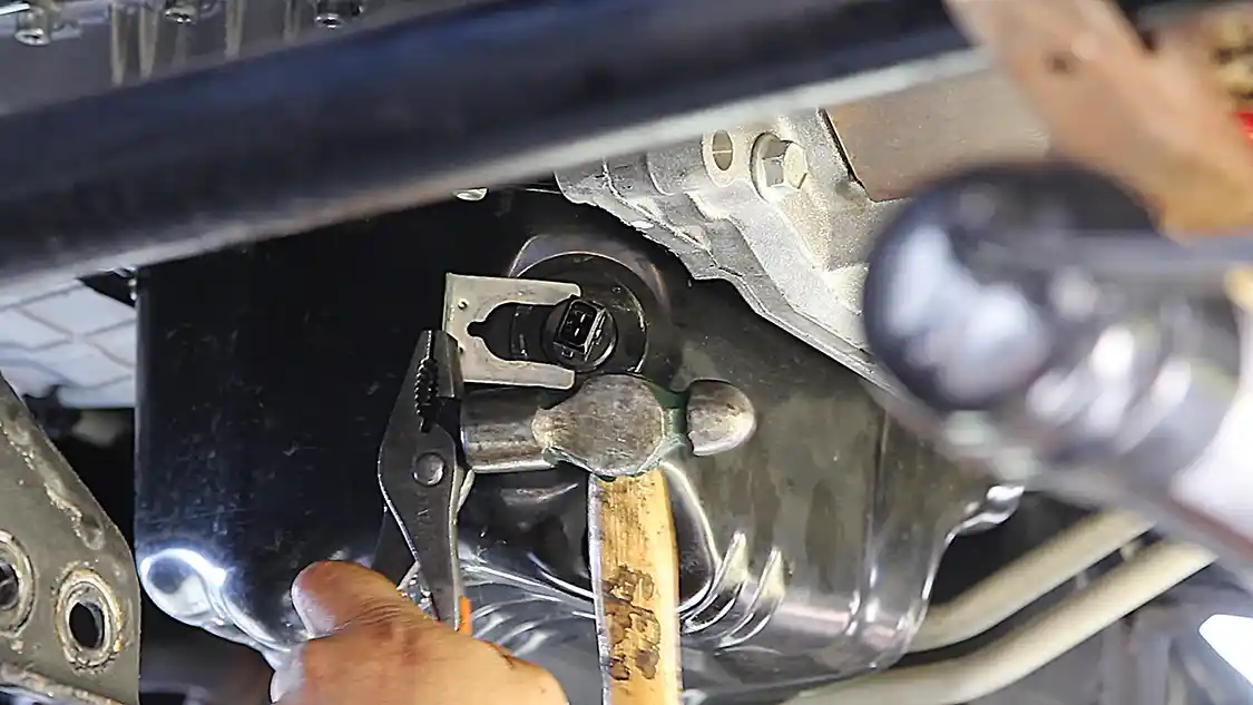 2. You will need to disconnect the factory low oil sensor electrical connector and move the wires out of the way. The sensor is then gently removed from the grommet and set aside for reuse.