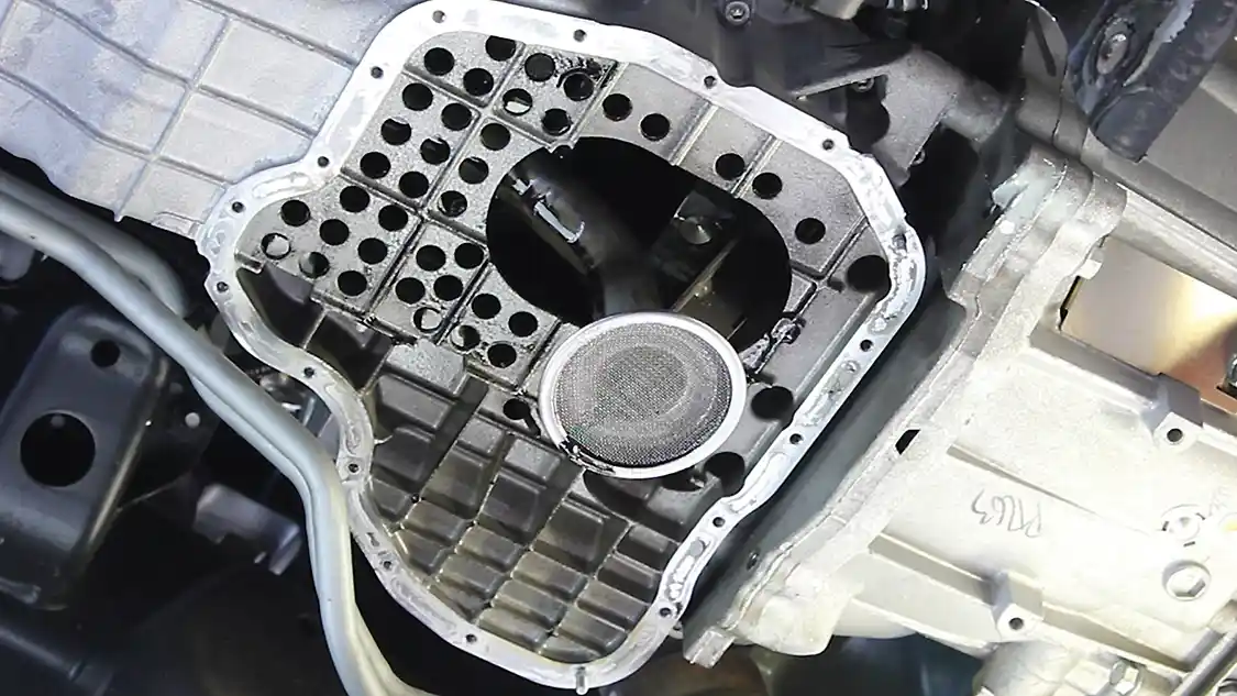 5. With the lower pan off, you can clean the old sealant off the upper oil pan mounting face. Take care to not scratch or gouge the mounting surface. Next, let the engine drain overnight to allow the old oil to drip out of the engine.
