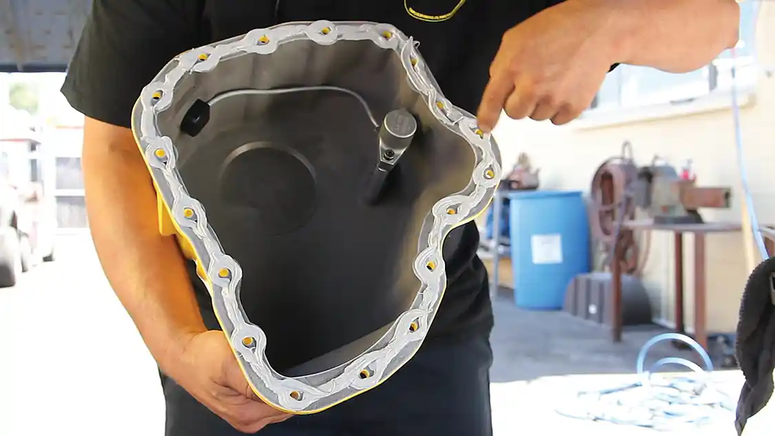 8. This photo shows how the sealant bead must be installed, evenly and around each mounting hole. It’s then installed on the engine in short order and allowed to setup for a day.