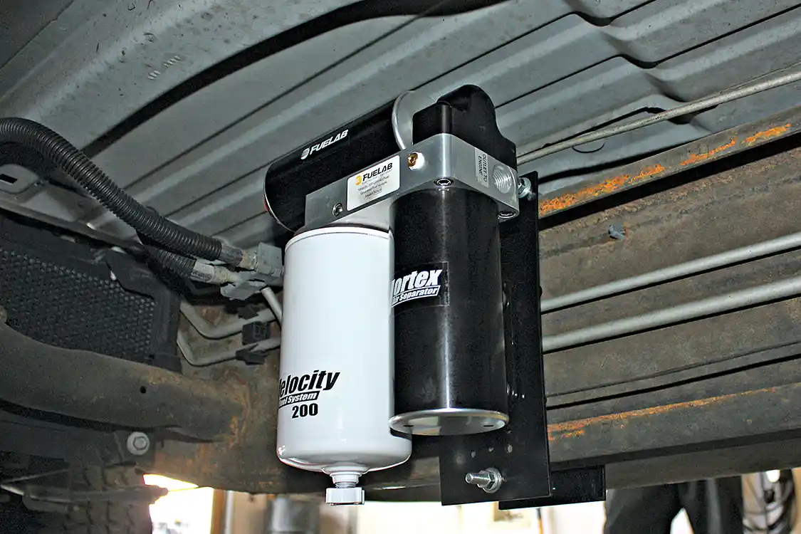 5. On the crew cab GM truck seen here, the Velocity kit fits directly in front of the fuel tank under the back driver-side door. On the Fuelab no-drill bracket, the pump can be mounted high enough that the base of the filter is barely visible from the side of the vehicle. Keeping it tucked up nice and close also helps keep it clear of road debris and keep the soon to be added fuel hoses routed cleanly inside the frame.