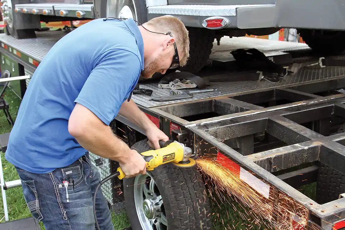 The team at Scheid Diesel repaired the broken trailer, rescued the stranded Topkick, and made the dyno trailer safe for operation, all in time to get the dyno back in service on Saturday. Here Adam Woodhouse grinds away some of the bad welds to make room for new welds by the Scheid crew.