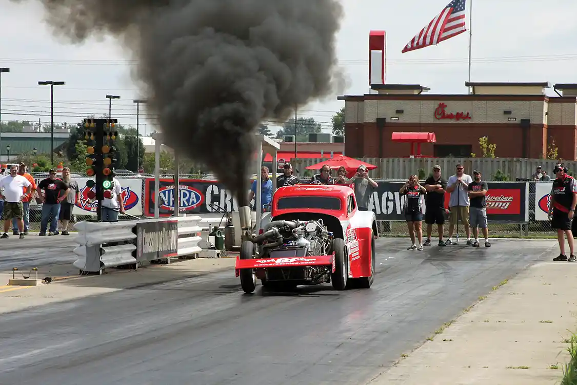 John Robinson and the Power Service altered blast off the line on the way to one of his four-second 1/8-mile passes, twisting the chassis and lifting the left front tire off the track.