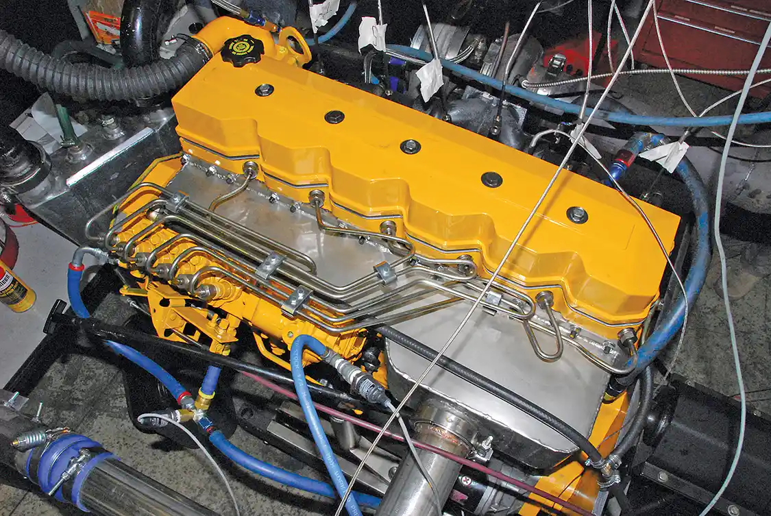 13. The Diesel Club fabricated a new large-plenum intake. The new Scheid Diesel 0.093-inch injector lines are also apparent in this view. The Diesel Club learned the hard way that the line clamps are there for a reason; they prevent fatigue fractures from vibration.
