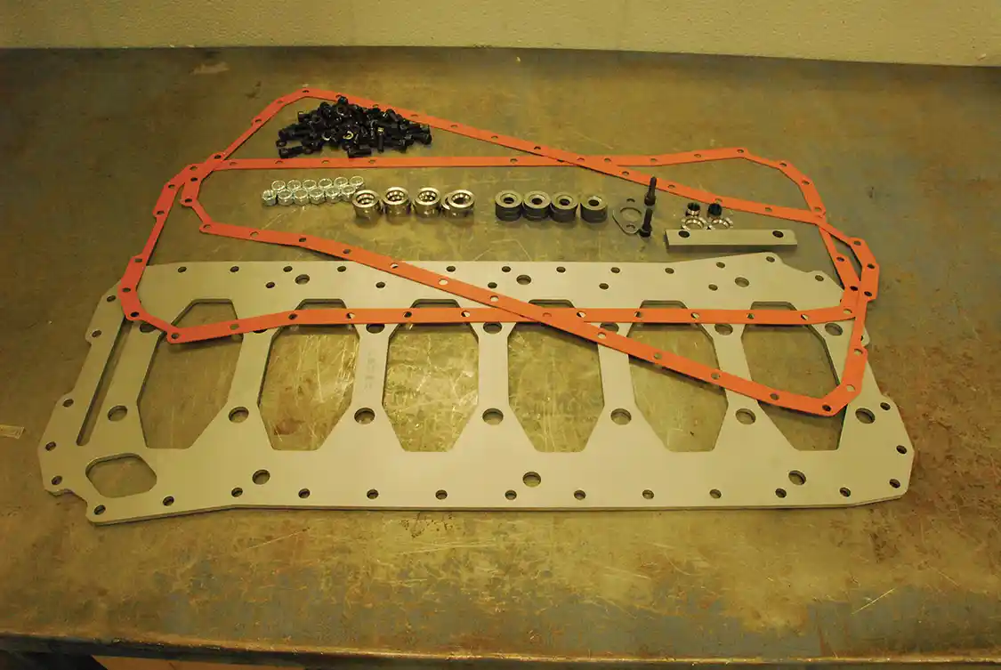 14. To help hold the lower end together, the stock girdle was replaced by a <a href="https://haisleymachine.com/">Haisley</a> Machine Gorilla Girdle. This is the kit contents; installers must add extra-long main bearing bolts. In this case, the stock 12mm bolts were replaced by high-strength 14mm bolts from ARP, which required drilling out and rethreading the block.