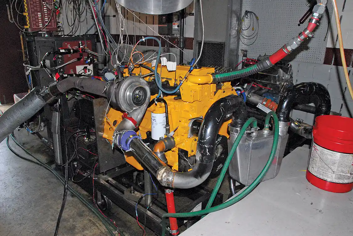 1. You can almost hear wrestling announcer Michael Buffer’s dramatic, “Let’s get ready rumble!” That’s not <a href="https://www.caterpillar.com/">Caterpillar</a> yellow, it’s Cummins Old Gold, the color Cummins engines were painted back in the 1950s and ’60s. In this photo, the engine is running the donated used turbo before it grenaded. Later, the <a href="https://www.precisionturbo.net/">Precision Turbo</a> was fitted. You can see the air-to-water intercooler, which is hooked up to a tap water hose. In the truck, ice water is used but even with 65 degree tap water, more than 100 degrees was knocked off the intake air temps.