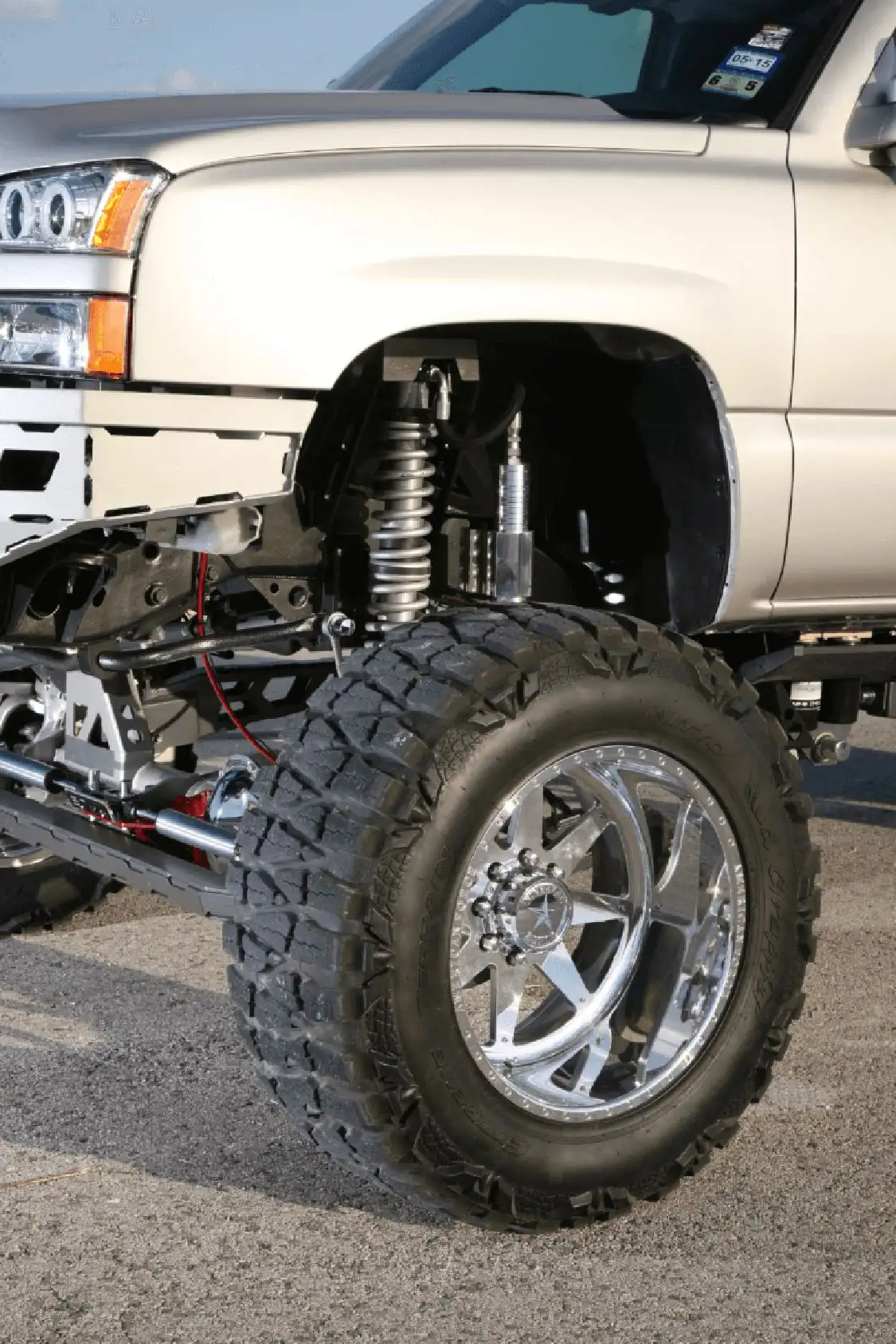 The Chevy rides on 22" <a href="https://americanforcewheels.com/">American Force</a> Evade FP8 wheels with <a href="https://www.nittotire.com/">Nitto</a> Mud Grappler tires, while 2-inch spacers give the truck its aggressive stance, and the shocks are 12-inch coilovers from Fox.