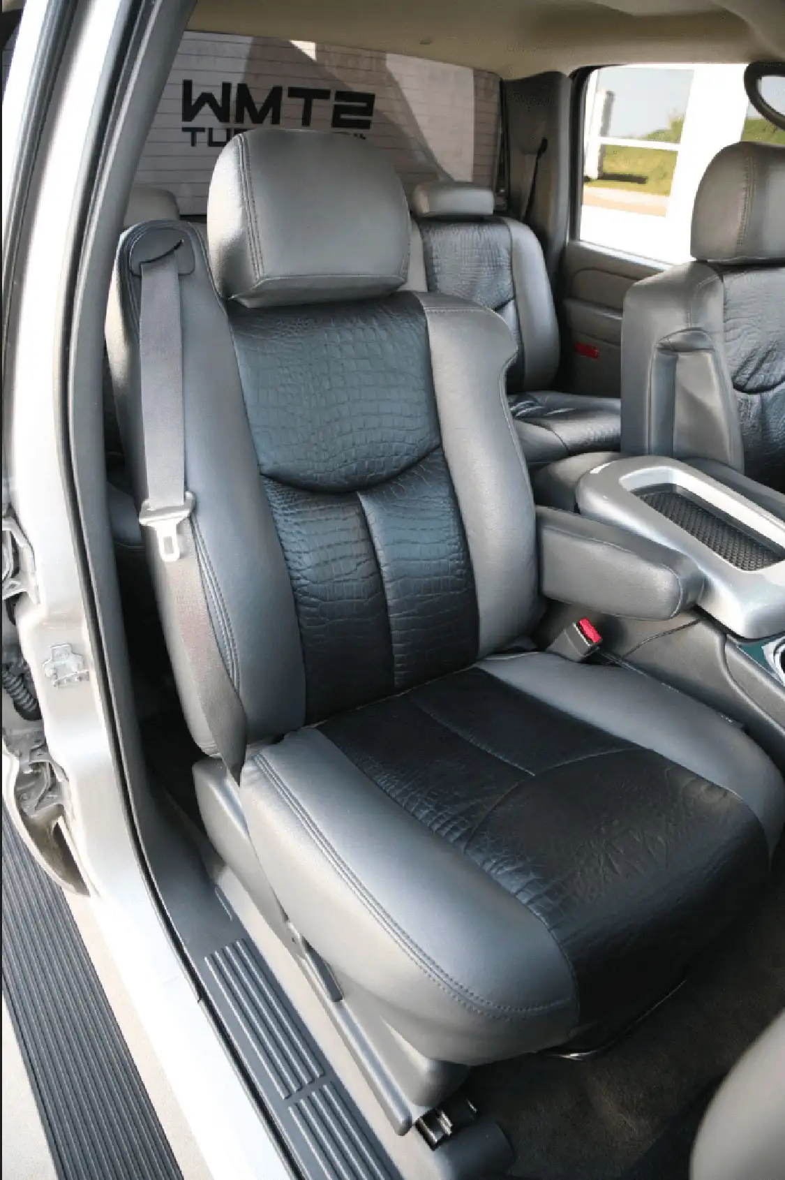 The seats were reupholstered by <a href="https://katzkin.com/">Katzkin</a>. Note the alligator-skin center section.