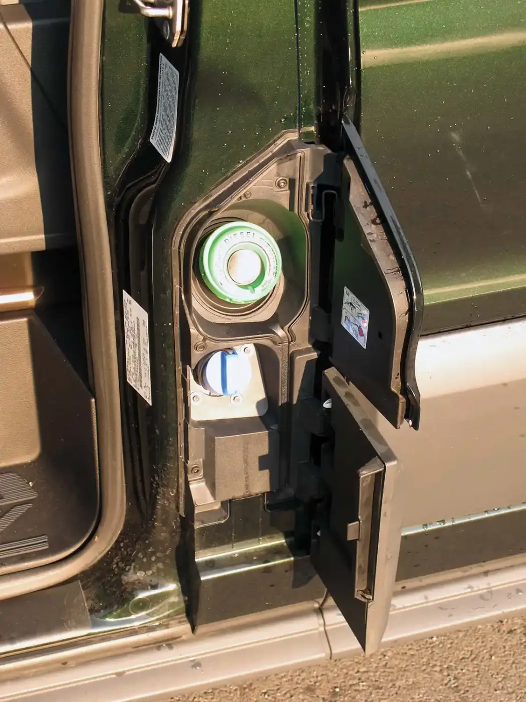The fuel fill door is hidden behind a panel next to the driver’s door. The driver’s door must be open to open the fuel fill door. Note, the DEF fill is located here too. 