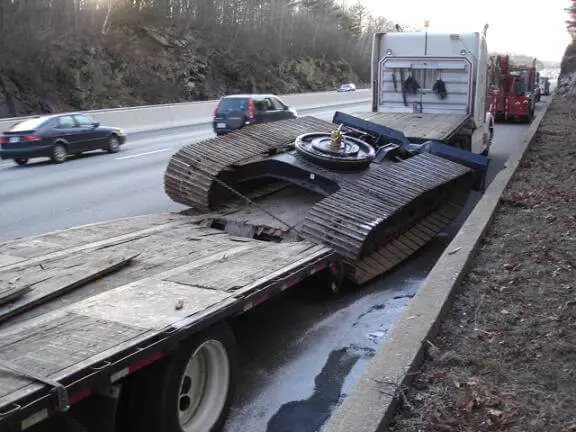 Low-bridge equipment hauling accident